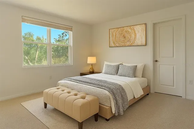 a bedroom with bed and a window