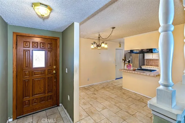 wooden floor with a chandelier