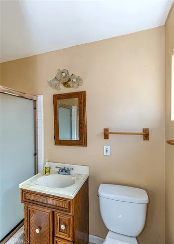 a bathroom with a sink a toilet and mirror