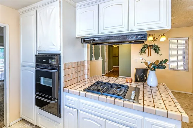a kitchen with an oven and cabinets