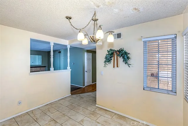 a view of a hallway with entryway and chandelier
