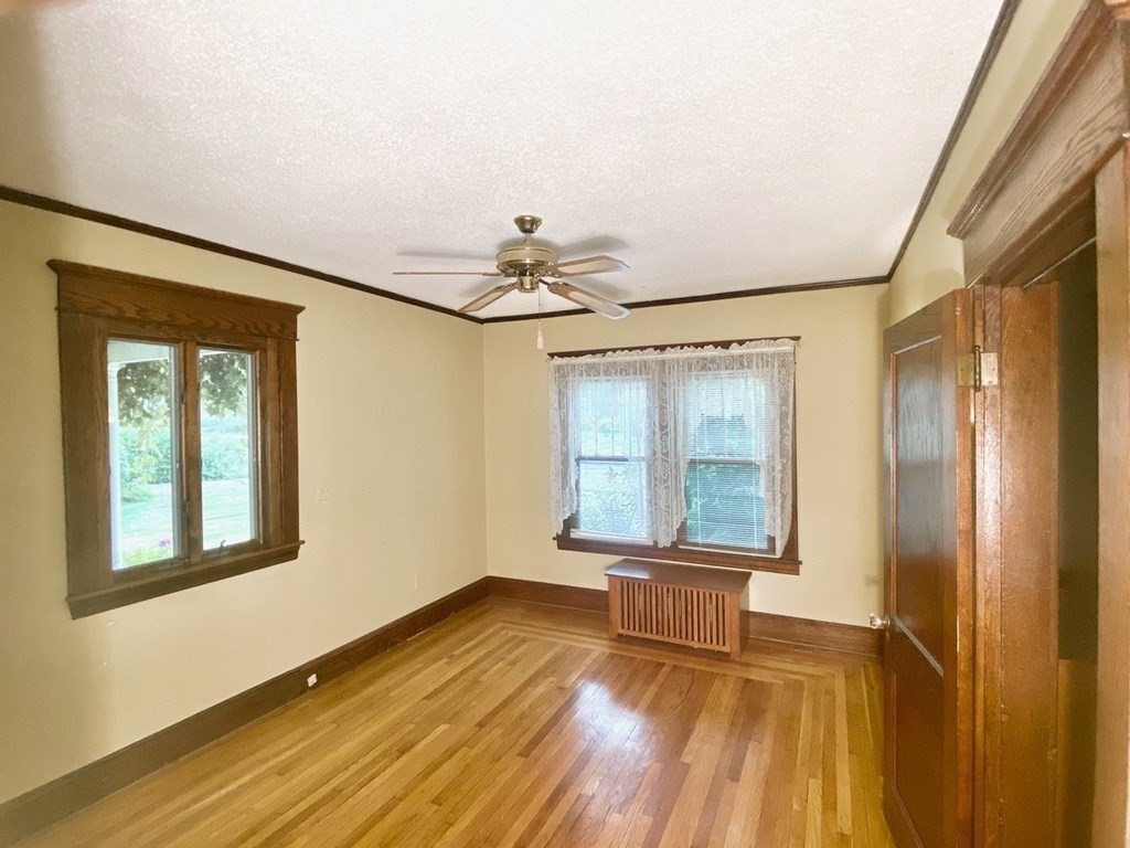 36 Maple Road Longmeadow, MA 01106 - Photo 6 of 21 a view of a livingroom with wooden floor and a ceiling fan