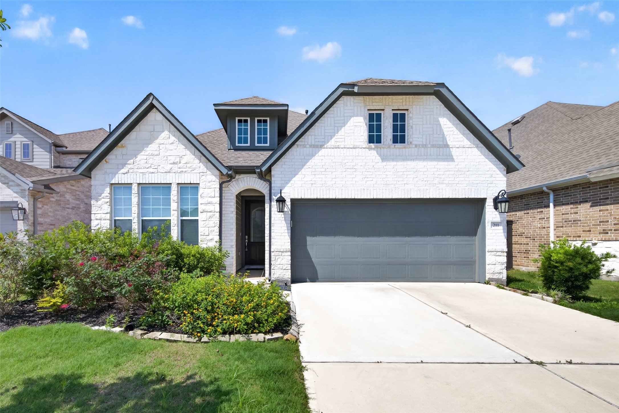 211 Amaranth Way Richmond, TX 77406 - Photo 1 of 26 a front view of a house with garage and yard