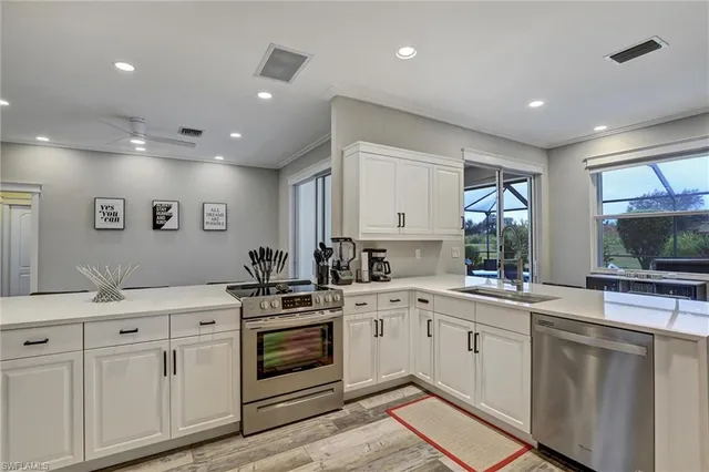 a kitchen with a sink stove and cabinets
