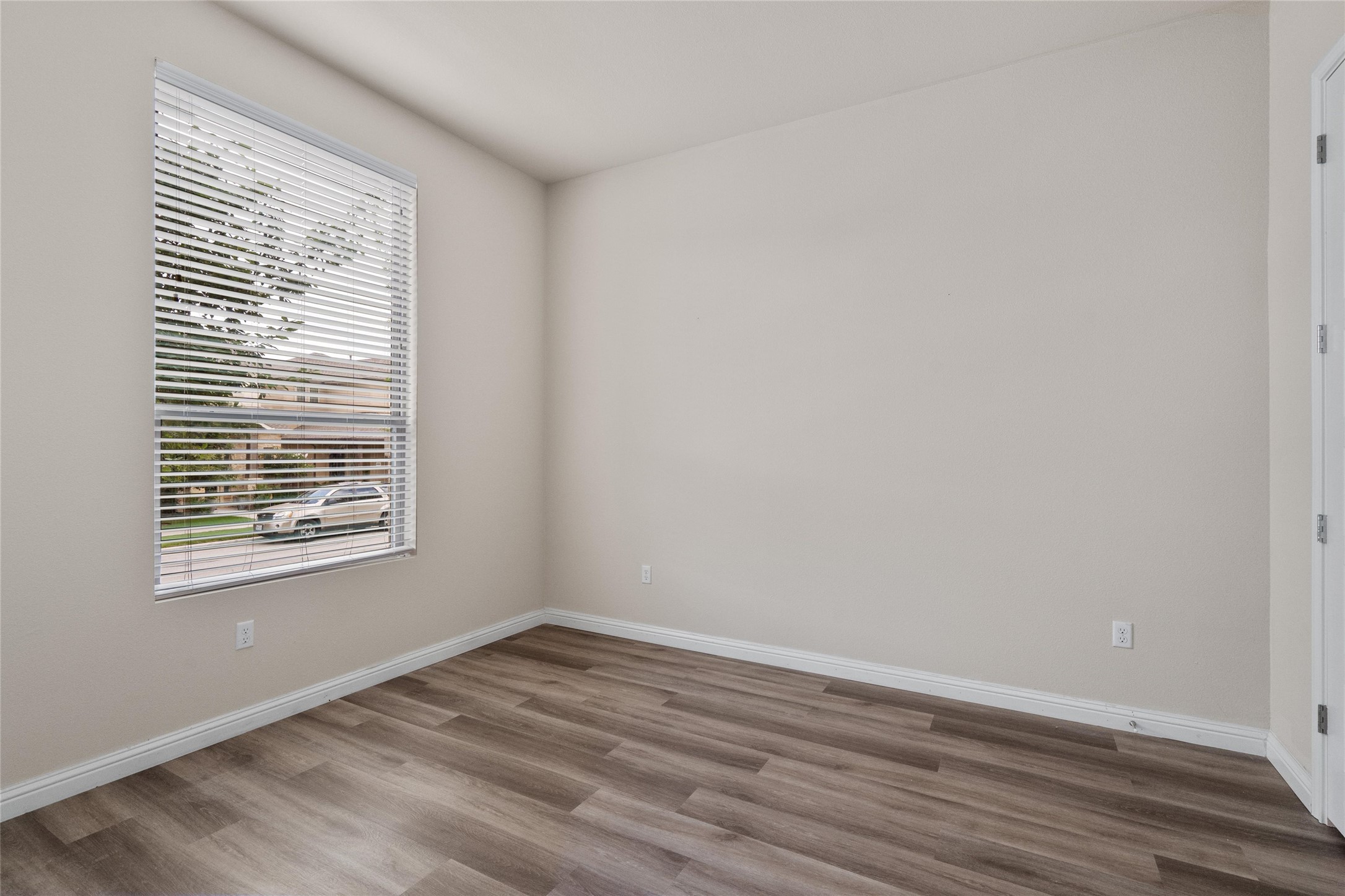 6907 Idea Road Austin, TX 78741 - Photo 12 of 36 a view of an empty room with wooden floor and a window