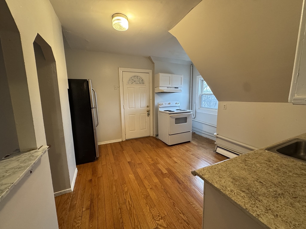 25 Amherst Street, Unit 4 Boston, MA 02131 - Photo 5 of 9 a view of kitchen and wooden floor