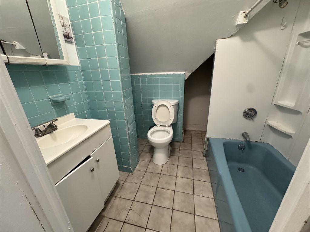 25 Amherst Street, Unit 4 Boston, MA 02131 - Photo 7 of 9 a bathroom with a sink a toilet and shower