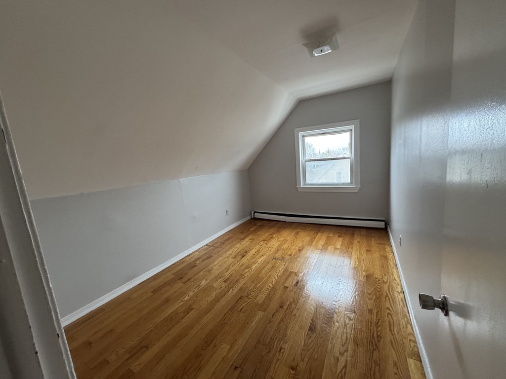 25 Amherst Street, Unit 4 Boston, MA 02131 - Photo 8 of 9 wooden floor in an empty room with a window