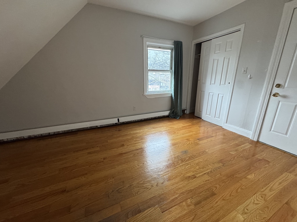 25 Amherst Street, Unit 4 Boston, MA 02131 - Photo 9 of 9 an empty room with wooden floor and windows