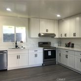 a kitchen with stainless steel appliances granite countertop a sink and cabinets