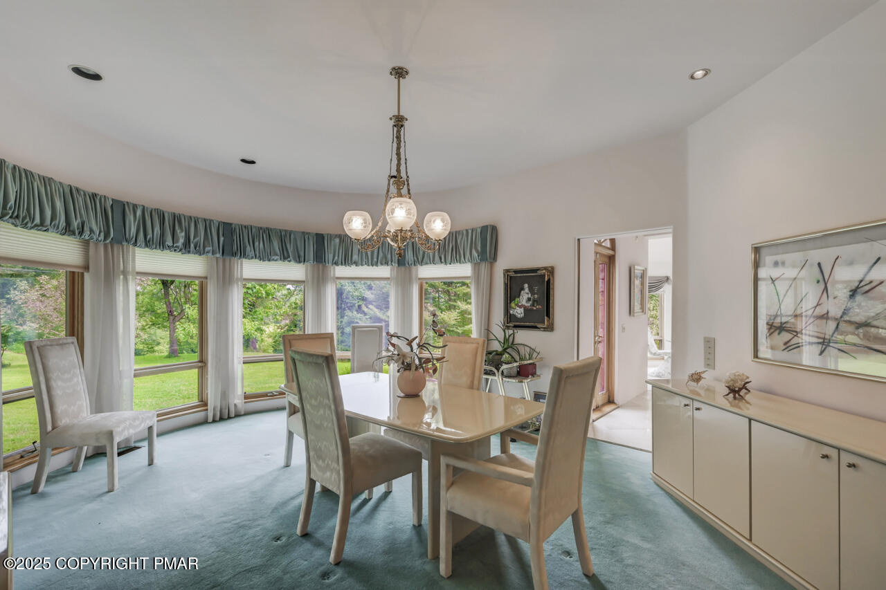 6696 Cherry Valley Road Stroudsburg, PA 18360 - Photo 22 of 97 a view of a dining room with furniture large windows and wooden floor