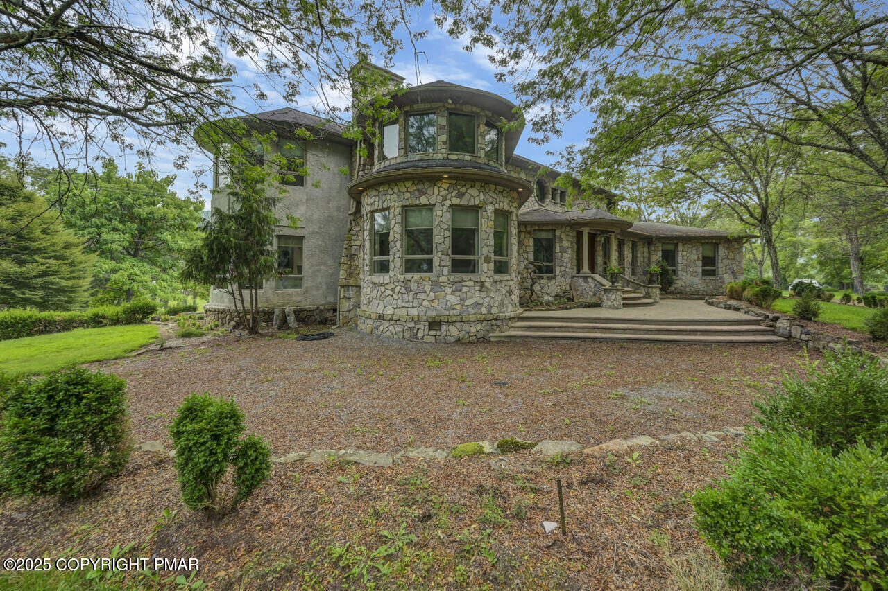 6696 Cherry Valley Road Stroudsburg, PA 18360 - Photo 6 of 97 a front view of a house with a yard