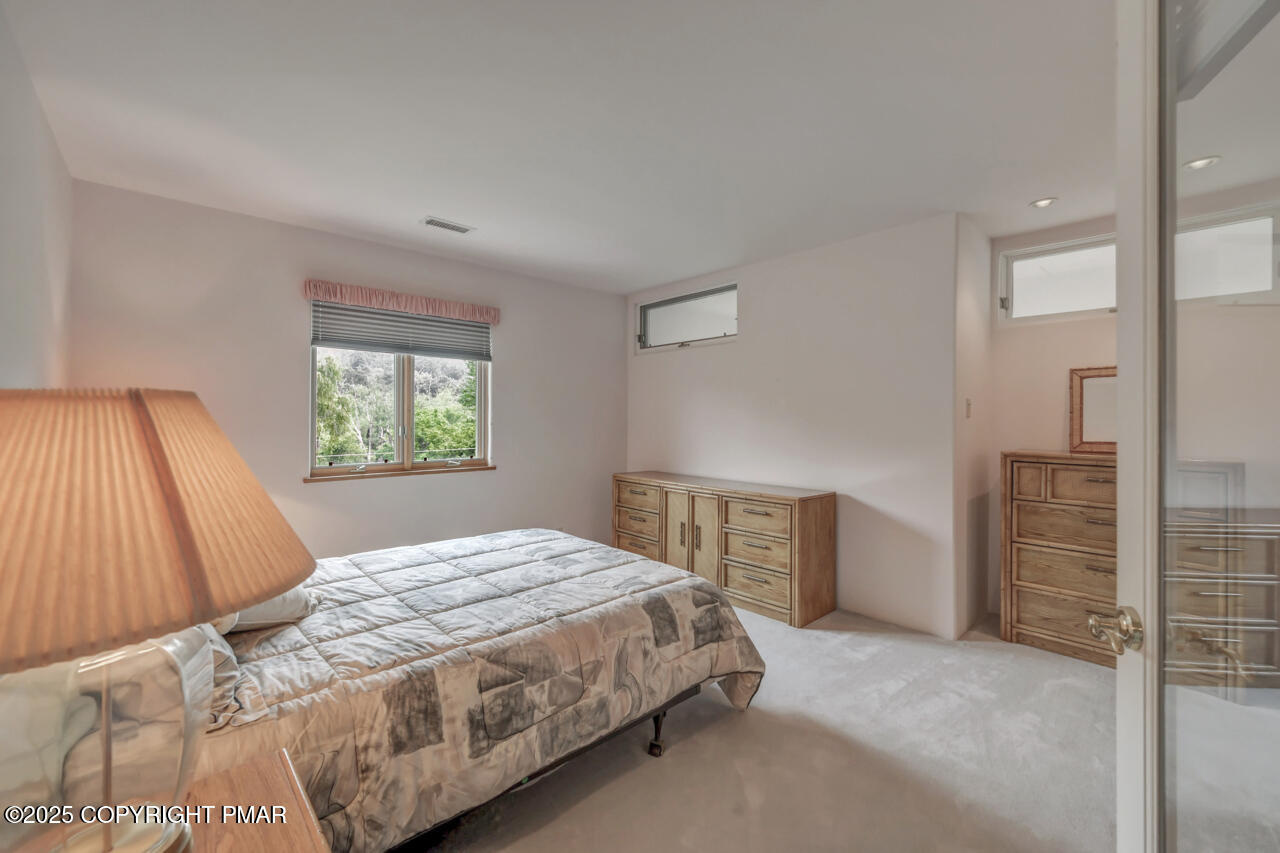 6696 Cherry Valley Road Stroudsburg, PA 18360 - Photo 63 of 97 a bedroom with a large bed and a window