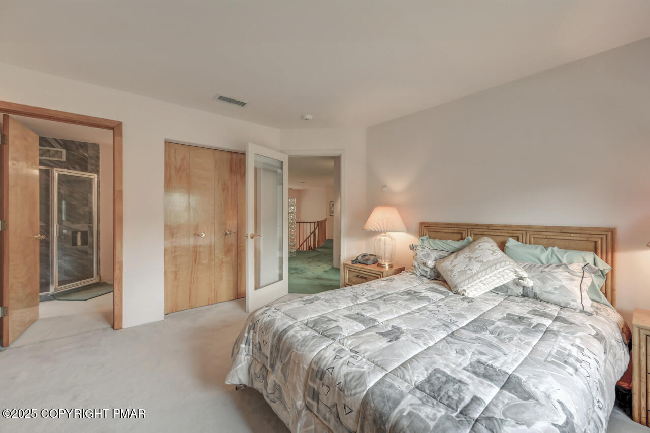 6696 Cherry Valley Road Stroudsburg, PA 18360 - Photo 64 of 97 a bedroom with a bed and a night stand