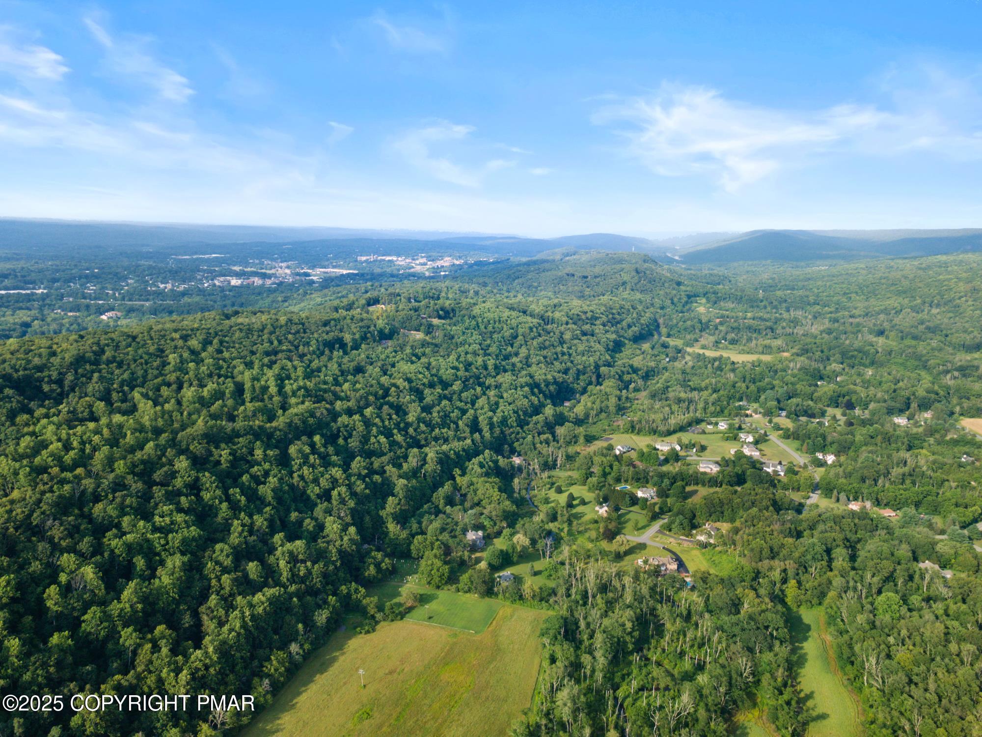 6696 Cherry Valley Road Stroudsburg, PA 18360 - Photo 97 of 97 a view of a city with lush green forest