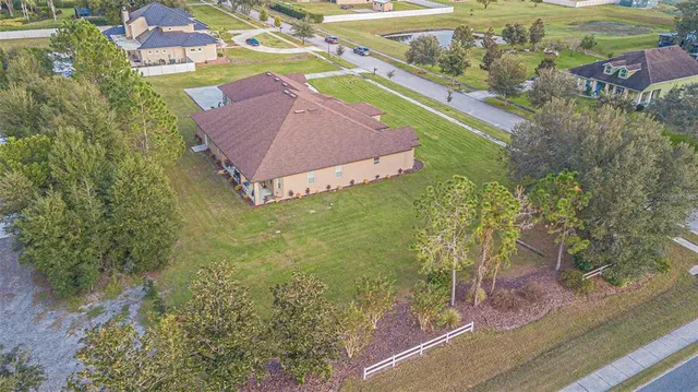 an aerial view of a house with a yard