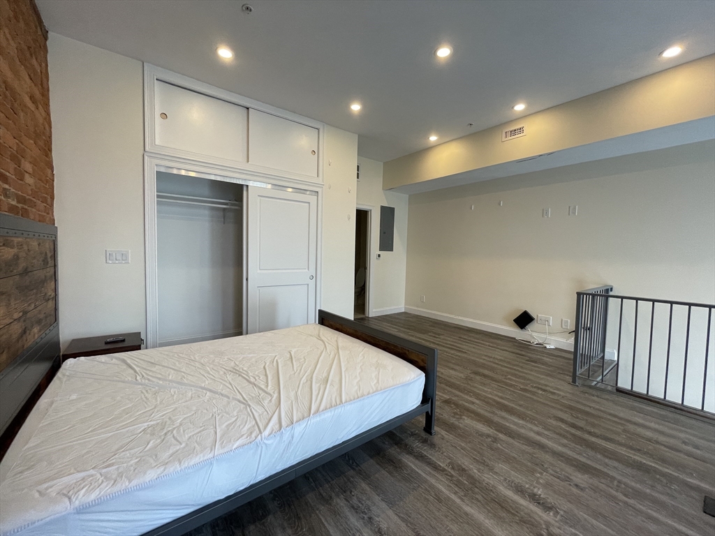 1028 Commonwealth Avenue, Unit 102 Boston, MA 02215 - Photo 7 of 11 a bedroom with a bed and a dresser