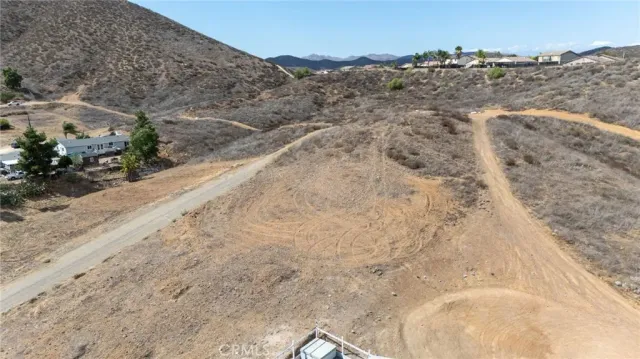 a view of a dry yard with mountains in the background