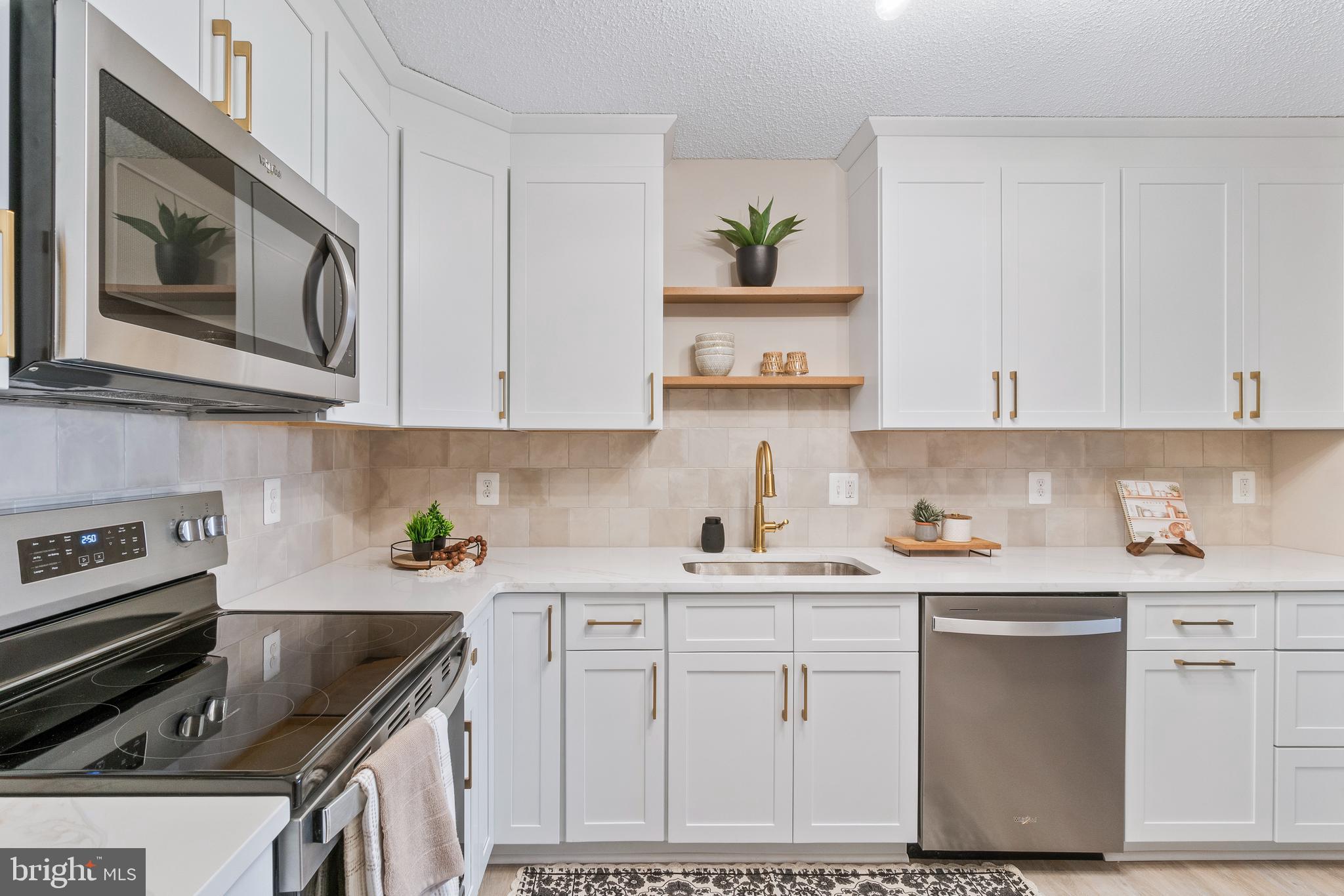 205 East Joppa Road, Unit 2703 Towson, MD 21286 - Photo 21 of 34 a kitchen with cabinets appliances and a counter top