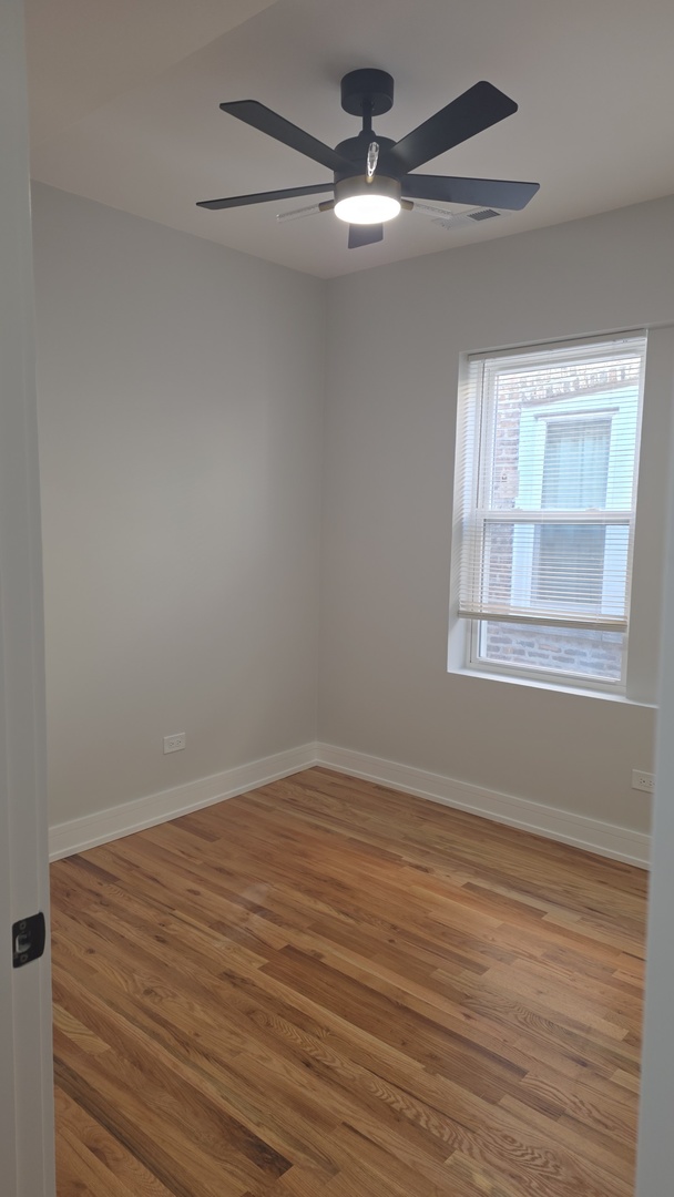 7607 South Evans Avenue Chicago, IL 60619 - Photo 7 of 15 a view of empty room with wooden floor