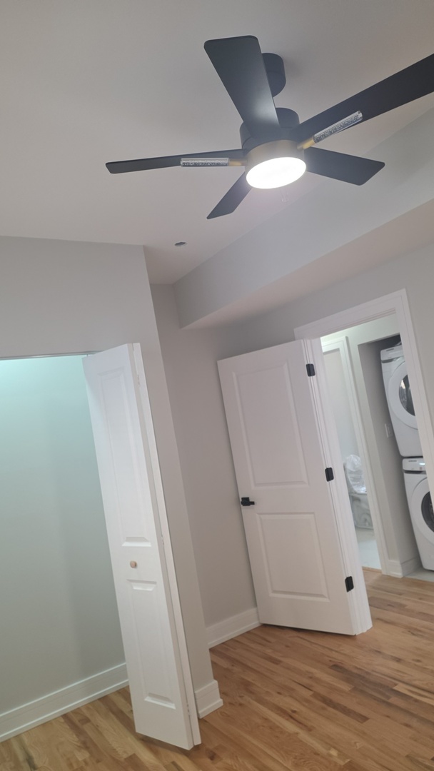 7607 South Evans Avenue Chicago, IL 60619 - Photo 8 of 15 an empty room with wooden floor and windows