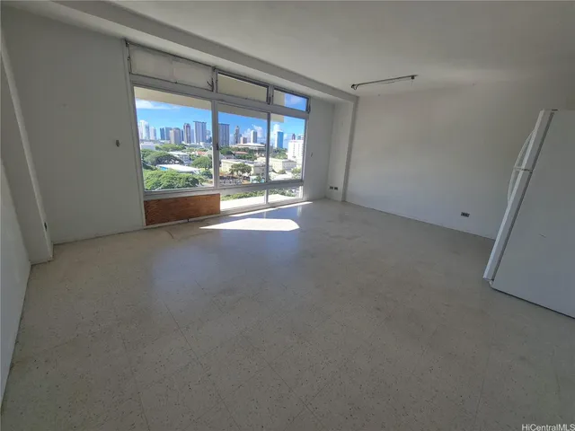 an empty room with a white cabinet and cabinet