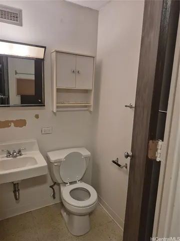a kitchen with a sink cabinets and wooden floor