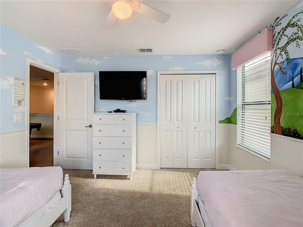 1305 Divot Way Davenport, FL 33896 - Photo 12 of 19 a bedroom with a bed and a flat screen tv