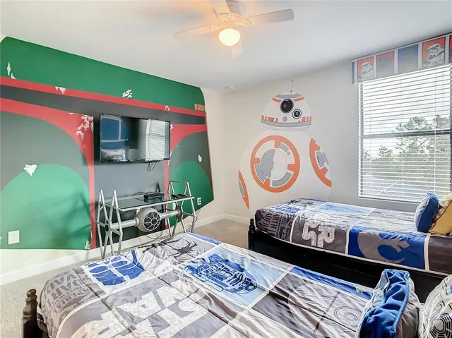 a bedroom with a bed and a bookshelf with wooden floor