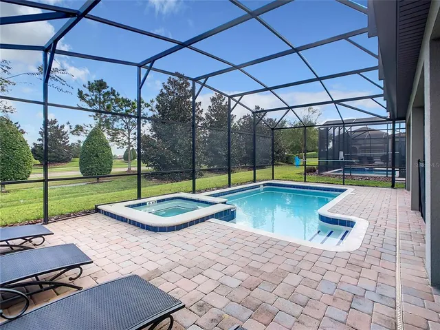 a view of a swimming pool with a patio