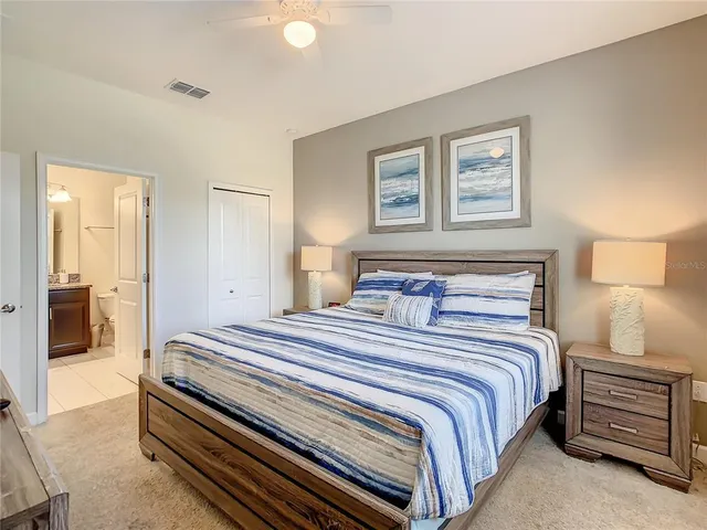 a bedroom with a bed and a lamp