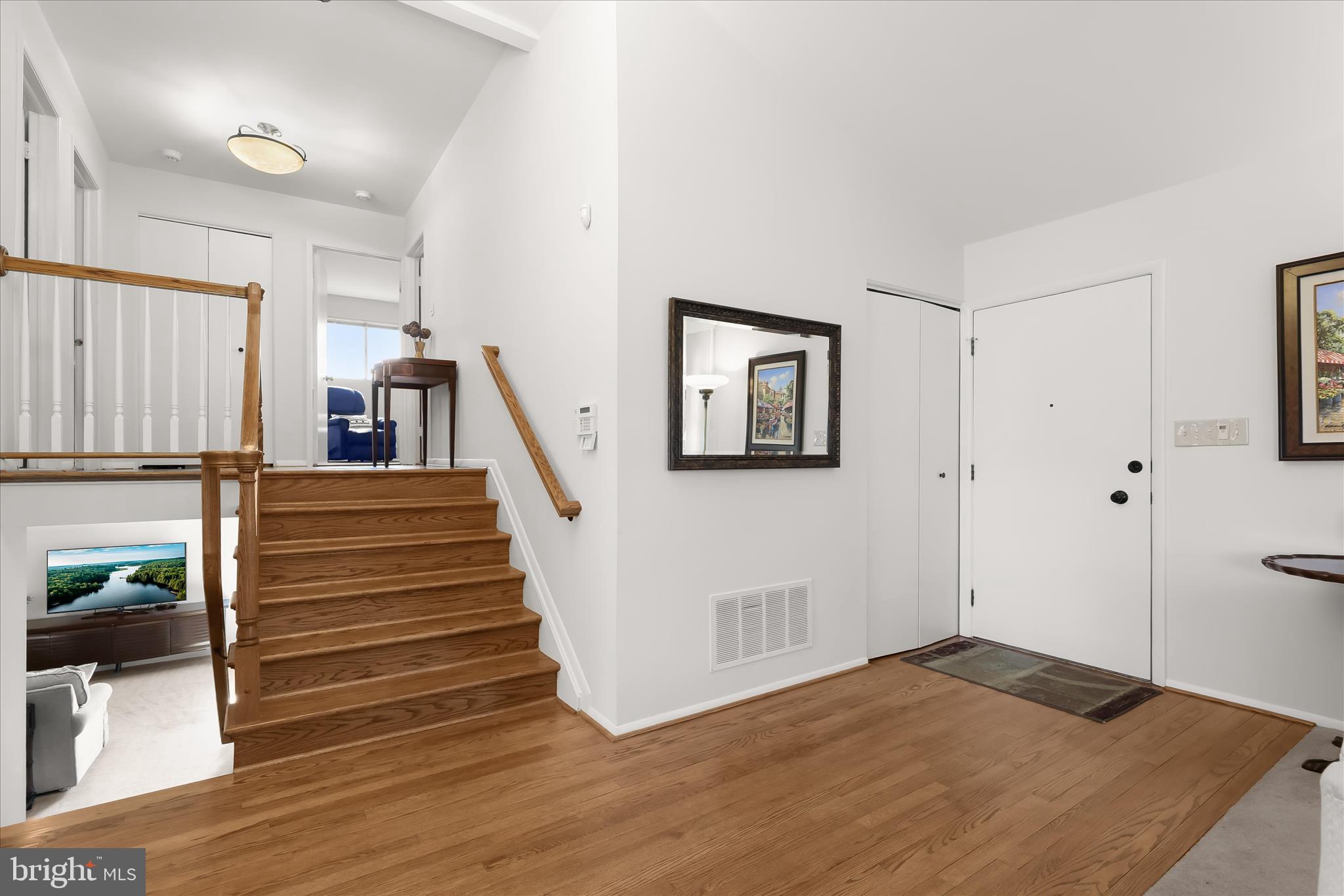 3416 Manor Hill Road Pikesville, MD 21208 - Photo 2 of 68 a view of a hallway with wooden floor and staircase