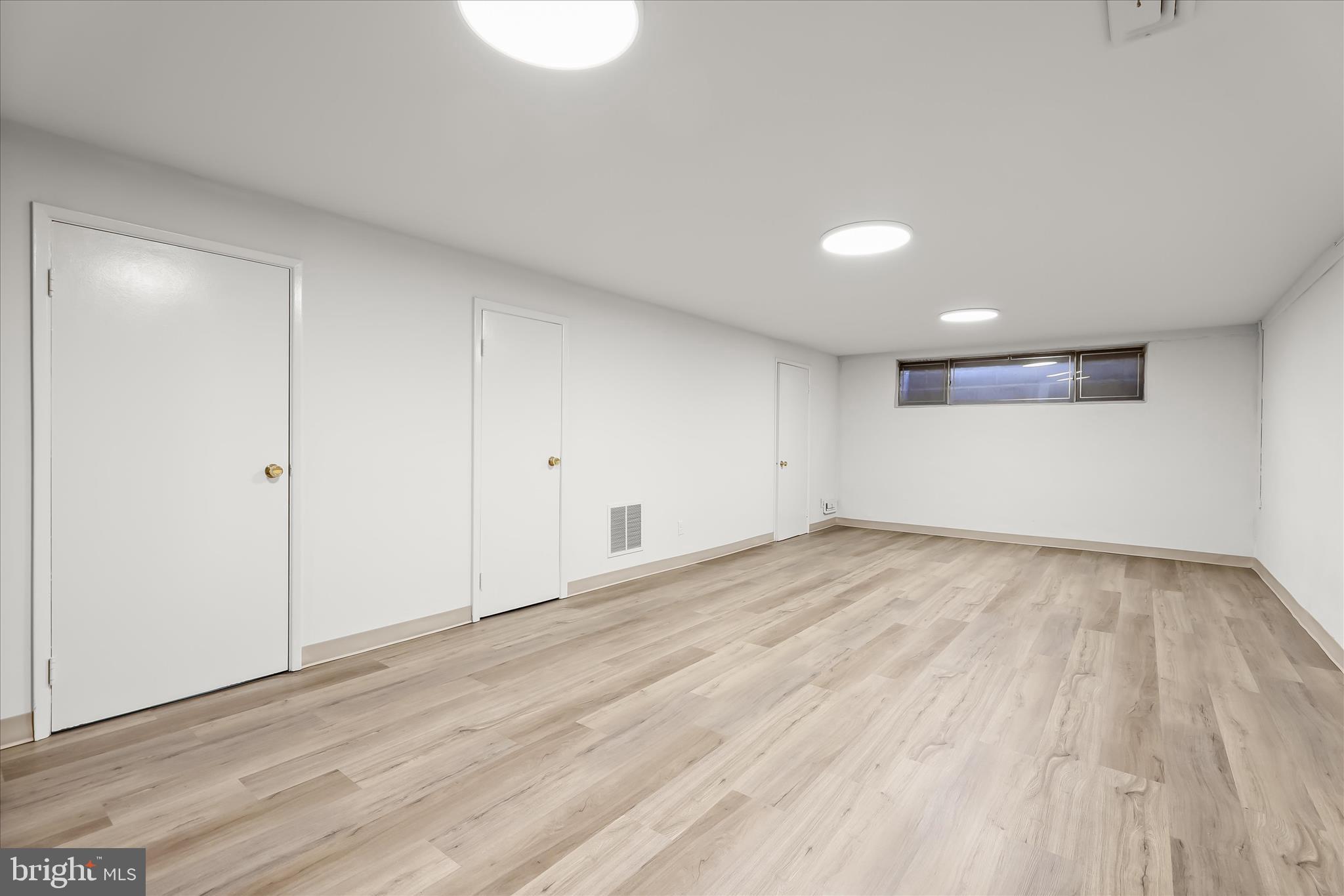 3416 Manor Hill Road Pikesville, MD 21208 - Photo 53 of 68 a view of an empty room with wooden floor