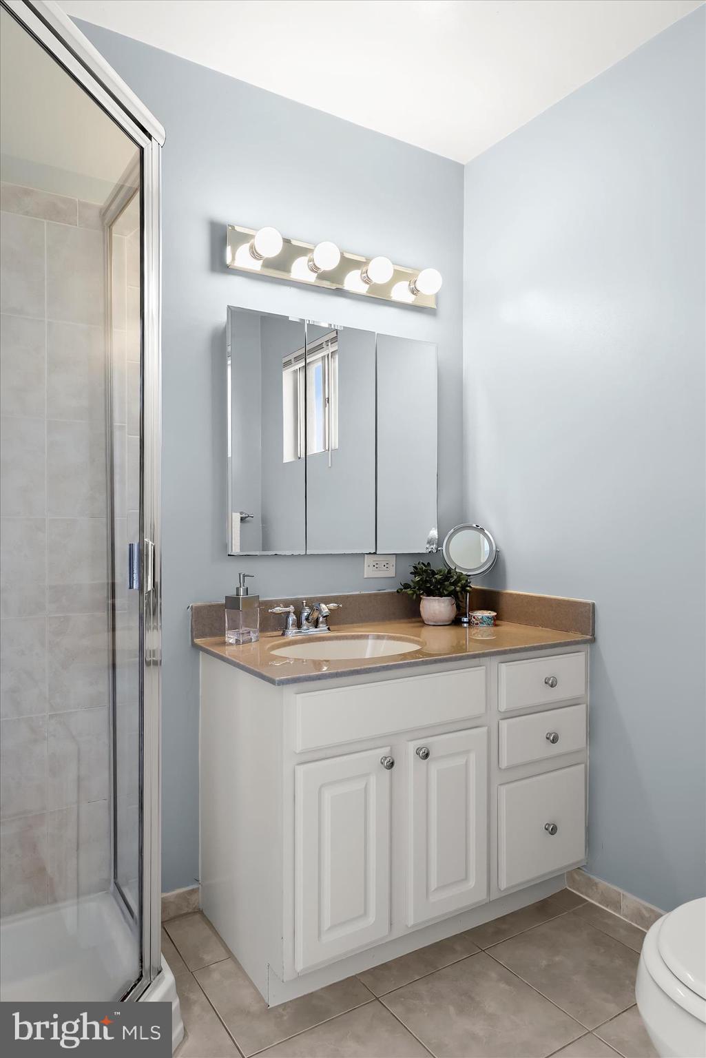 3416 Manor Hill Road Pikesville, MD 21208 - Photo 66 of 68 a bathroom with a granite countertop sink a toilet and a mirror