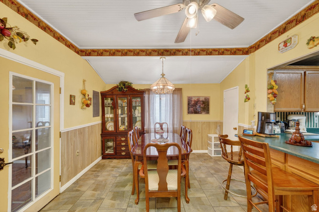977 23rd Street Ogden, UT 84401 - Photo 16 of 29 Dining space with a wainscoted wall, wooden walls, hanging lights, and a ceiling fan