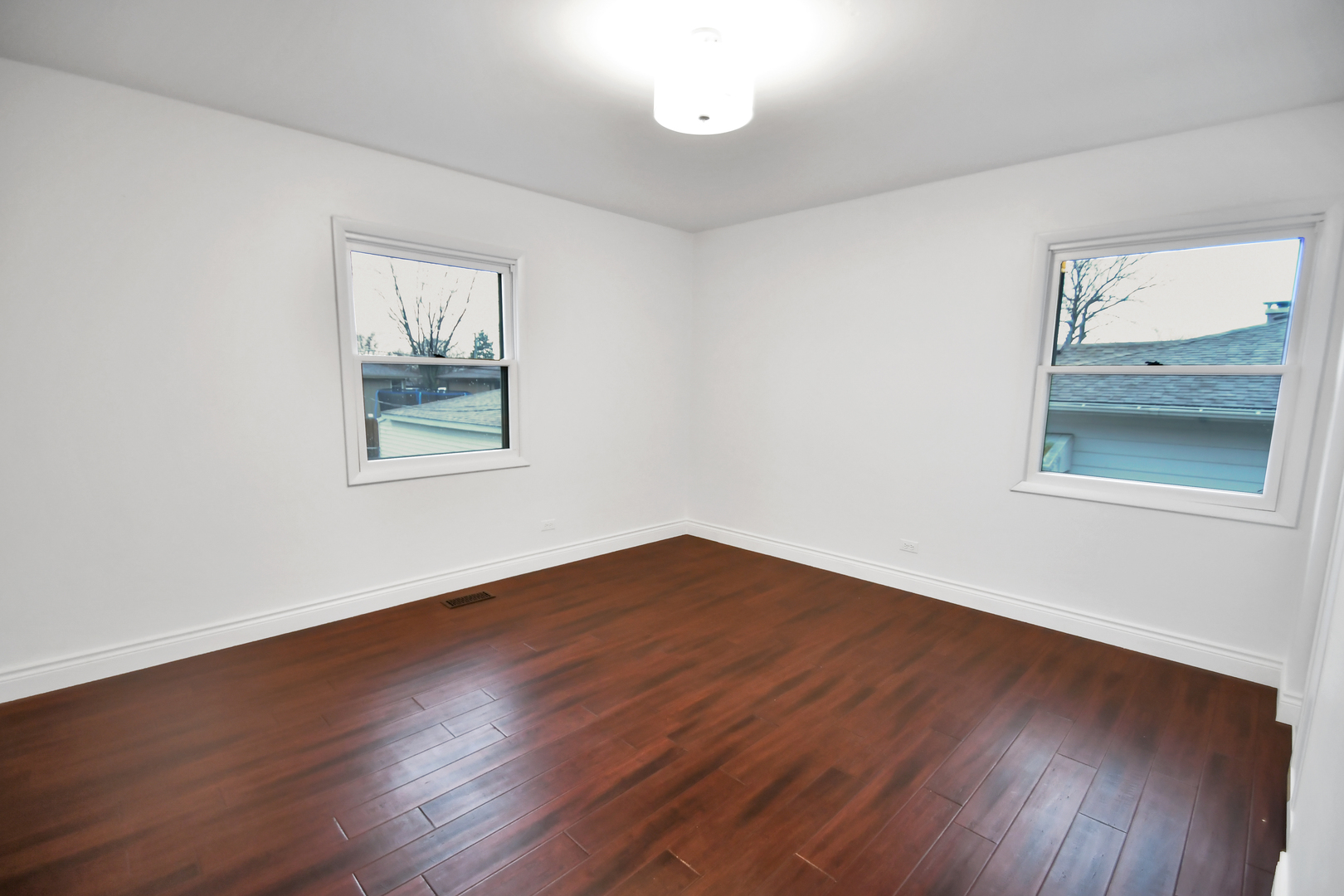 809 Cove Avenue Lockport, IL 60441 - Photo 16 of 22 a view of an empty room with wooden floor and a window