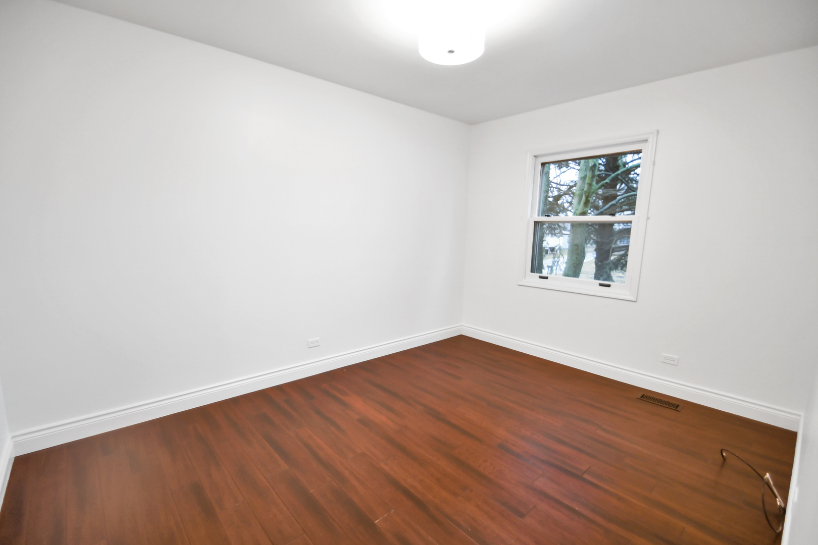809 Cove Avenue Lockport, IL 60441 - Photo 17 of 22 an empty room with wooden floor and windows
