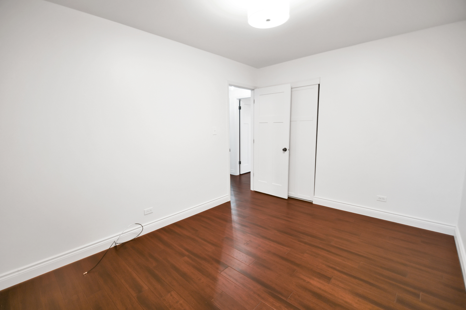 809 Cove Avenue Lockport, IL 60441 - Photo 18 of 22 a view of an empty room with wooden floor