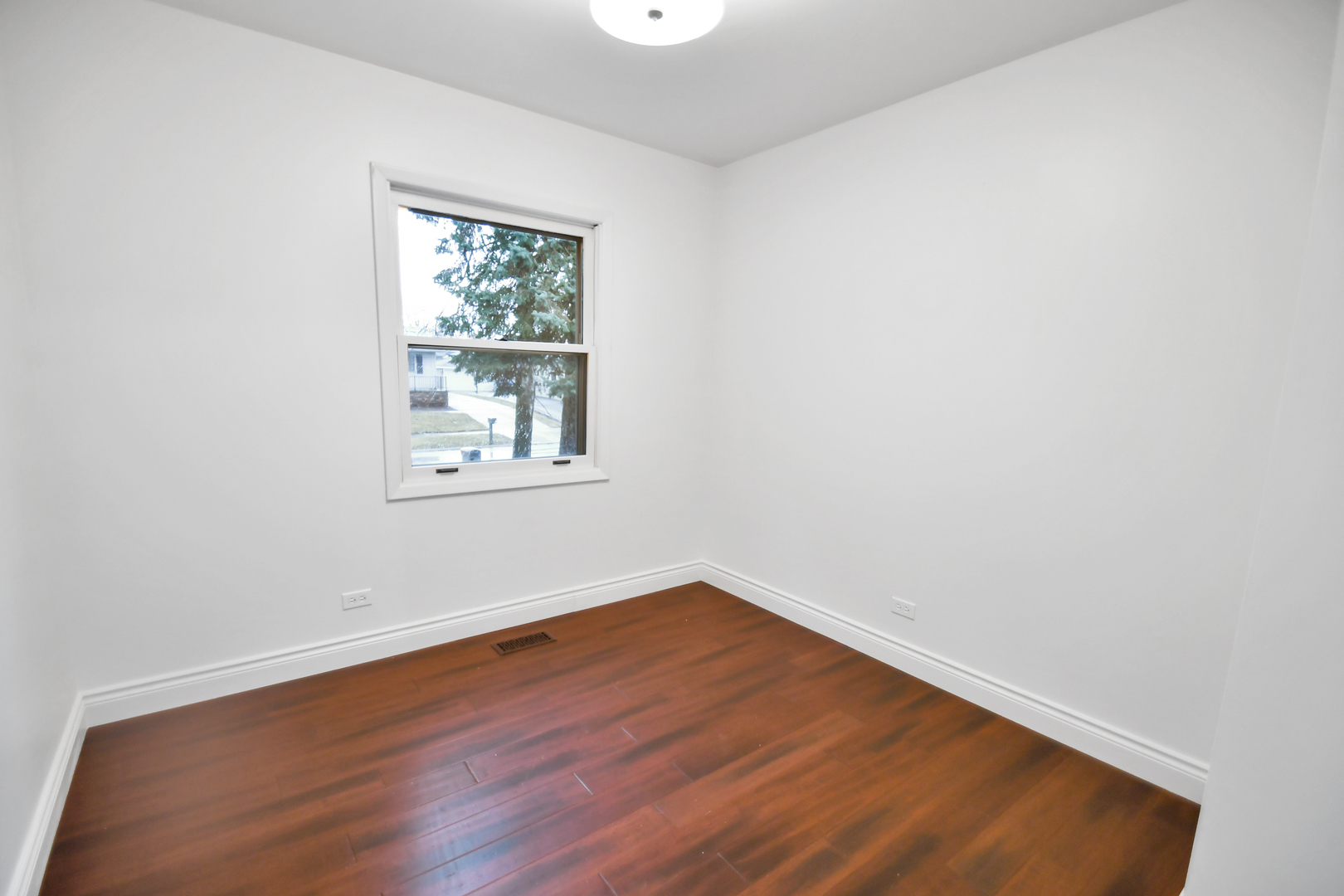 809 Cove Avenue Lockport, IL 60441 - Photo 19 of 22 an empty room with wooden floor and windows