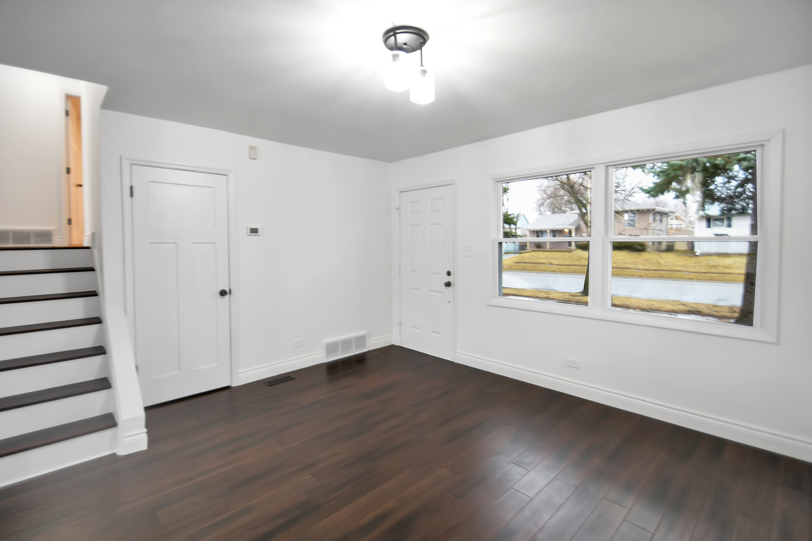 809 Cove Avenue Lockport, IL 60441 - Photo 4 of 22 an empty room with wooden floor and windows