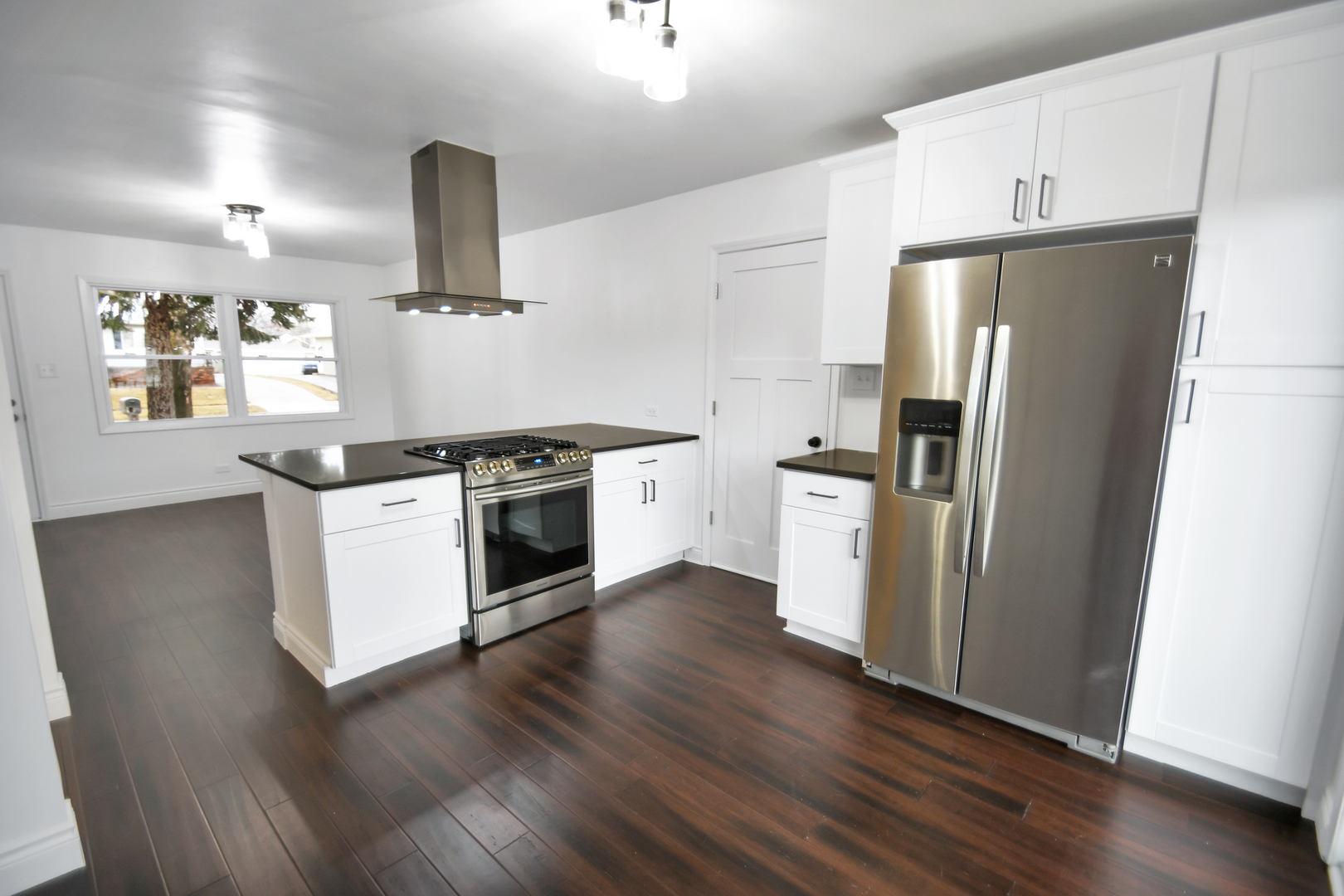 809 Cove Avenue Lockport, IL 60441 - Photo 6 of 22 a kitchen with wooden floors and stainless steel appliances