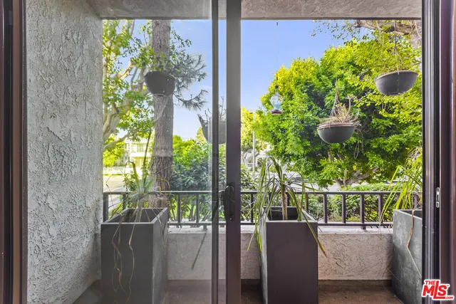 a view of a porch with a table & chairs
