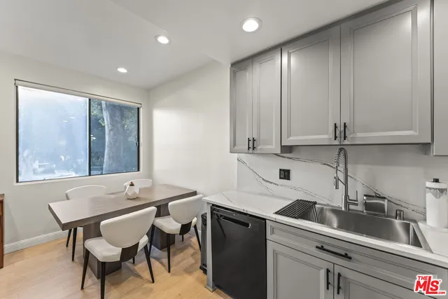 a kitchen with a sink cabinets and window