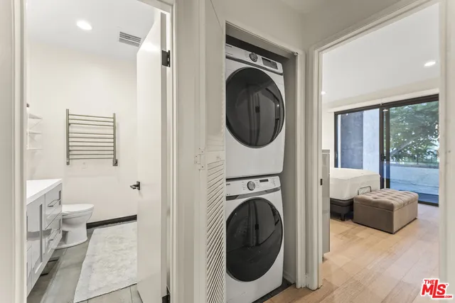 a view of a hallway with washer and dryer