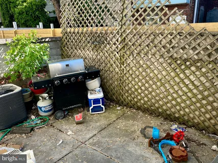 a view of a chairs and table in back yard of the house
