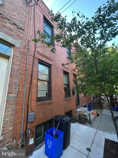 a red brick house with trees in front of it