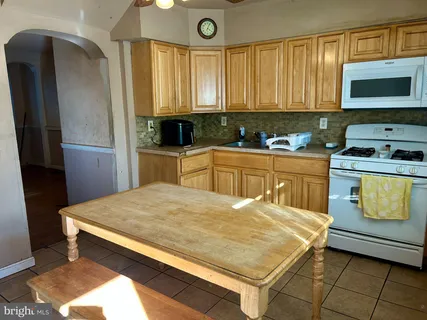 a kitchen with a stove a sink and a microwave