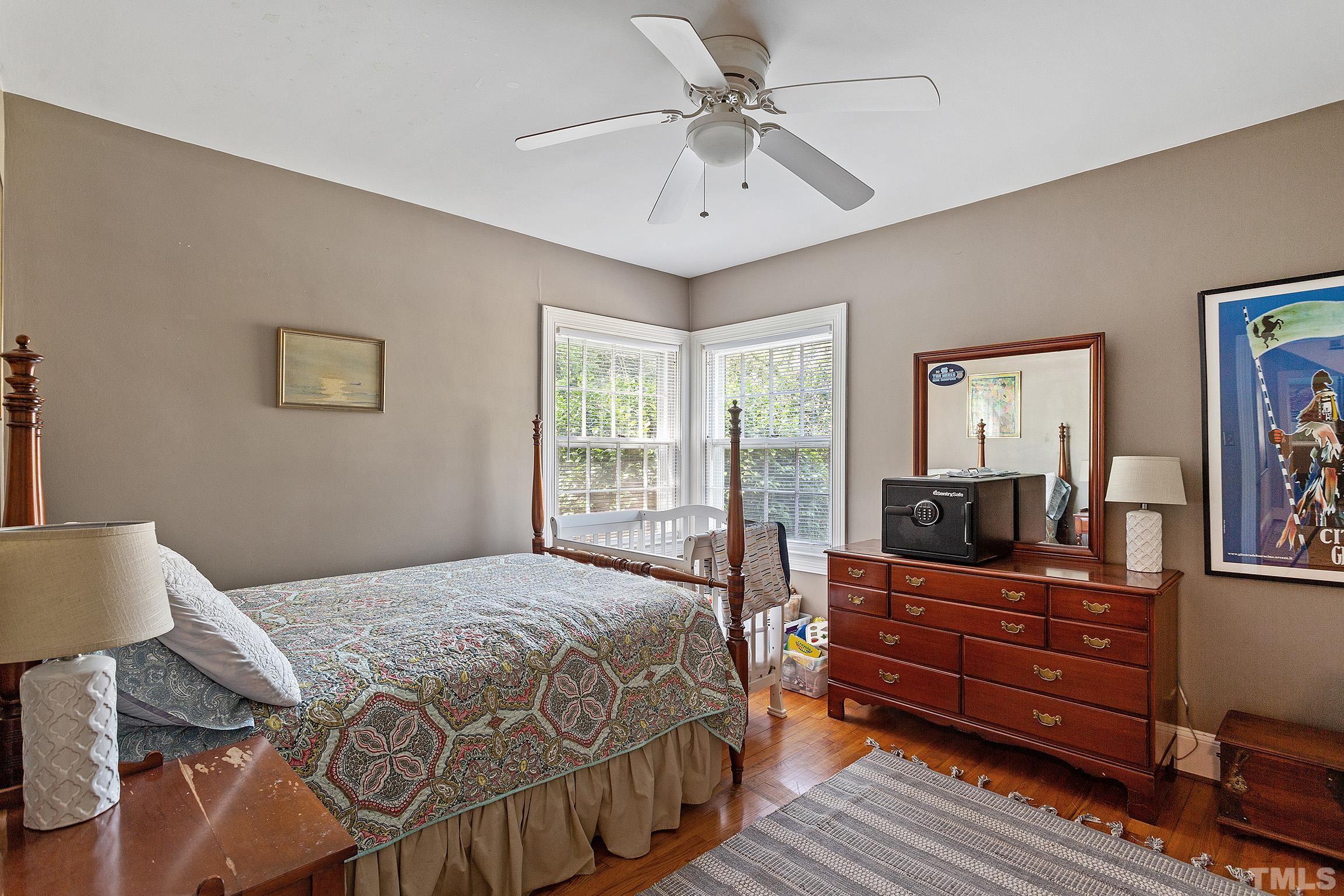 121 Lake Boone Trail Raleigh, NC 27608 - Photo 17 of 29 a bedroom with a bed and wooden floor