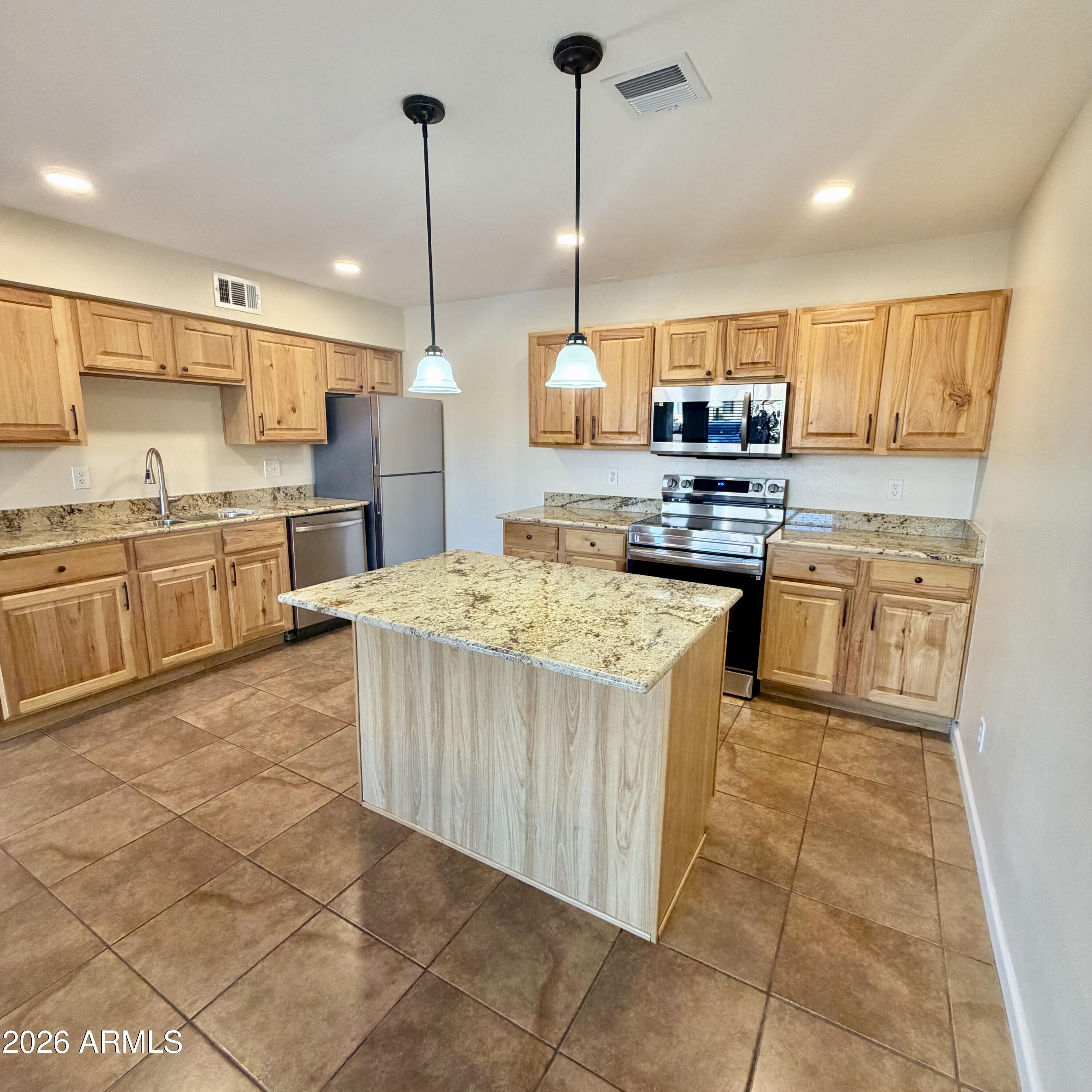 1440 North Idaho Road, Unit 1024 Apache Junction, AZ 85119 - Photo 2 of 9 a kitchen with stainless steel appliances granite countertop a stove a sink dishwasher and a refrigerator