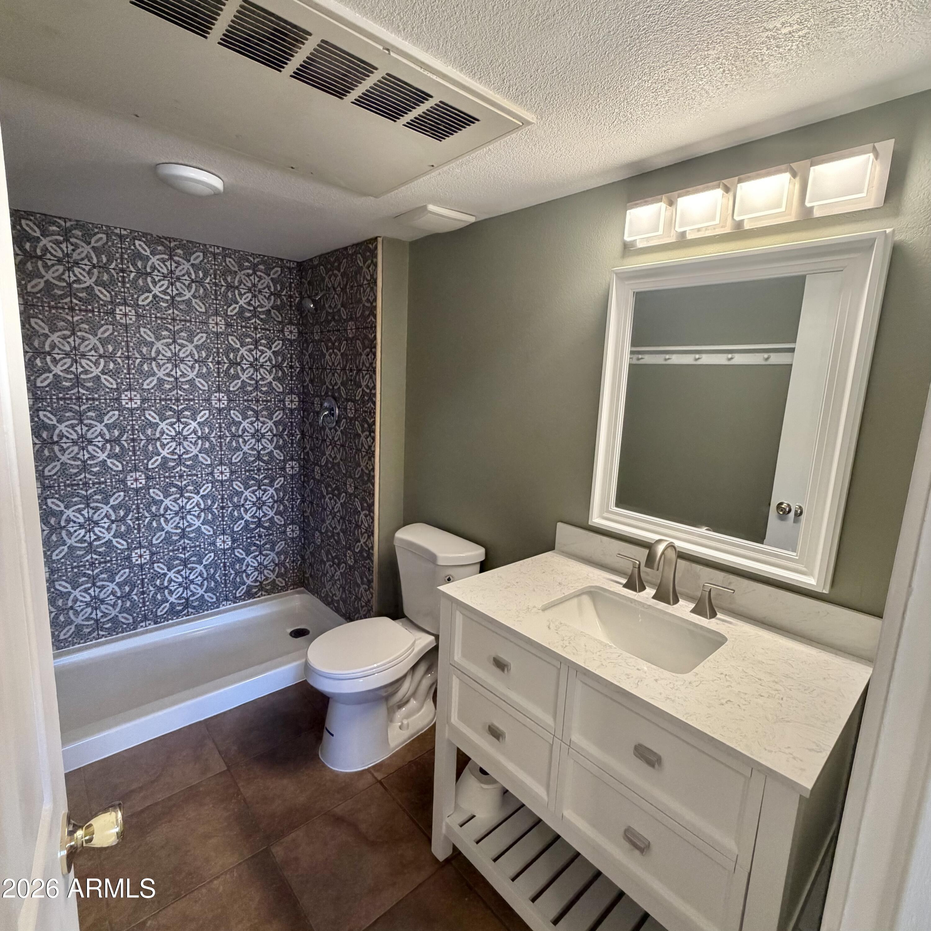 1440 North Idaho Road, Unit 1024 Apache Junction, AZ 85119 - Photo 5 of 9 a bathroom with a sink vanity mirror and toilet